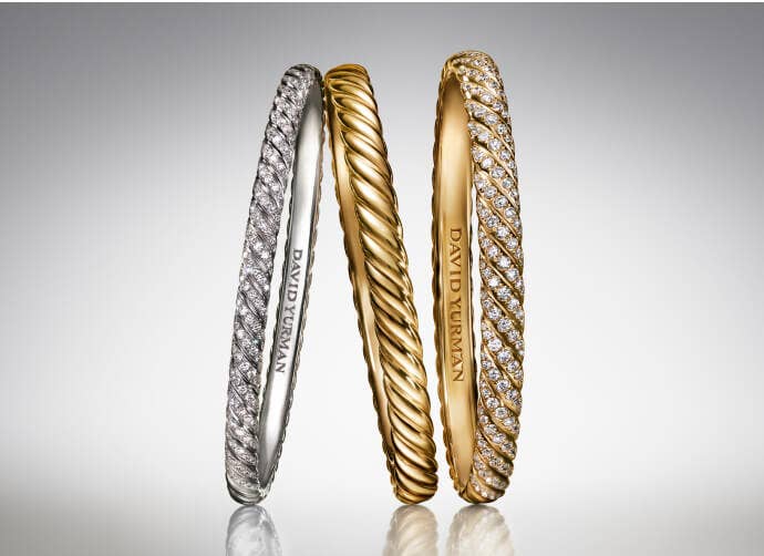 Three David Yurman Sculpted Cable bangles for women.