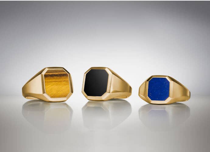 Three David Yurman Streamline rings for men.