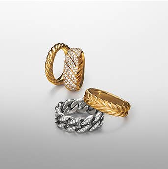 A variety of David Yurman rings in gold and silver.